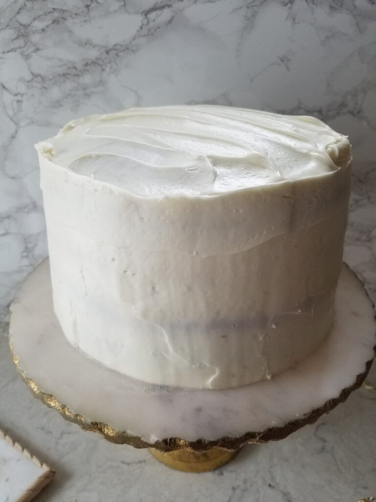 surprise carrot cake with 1 layer of frosting on it to seal the edges of the cake 
