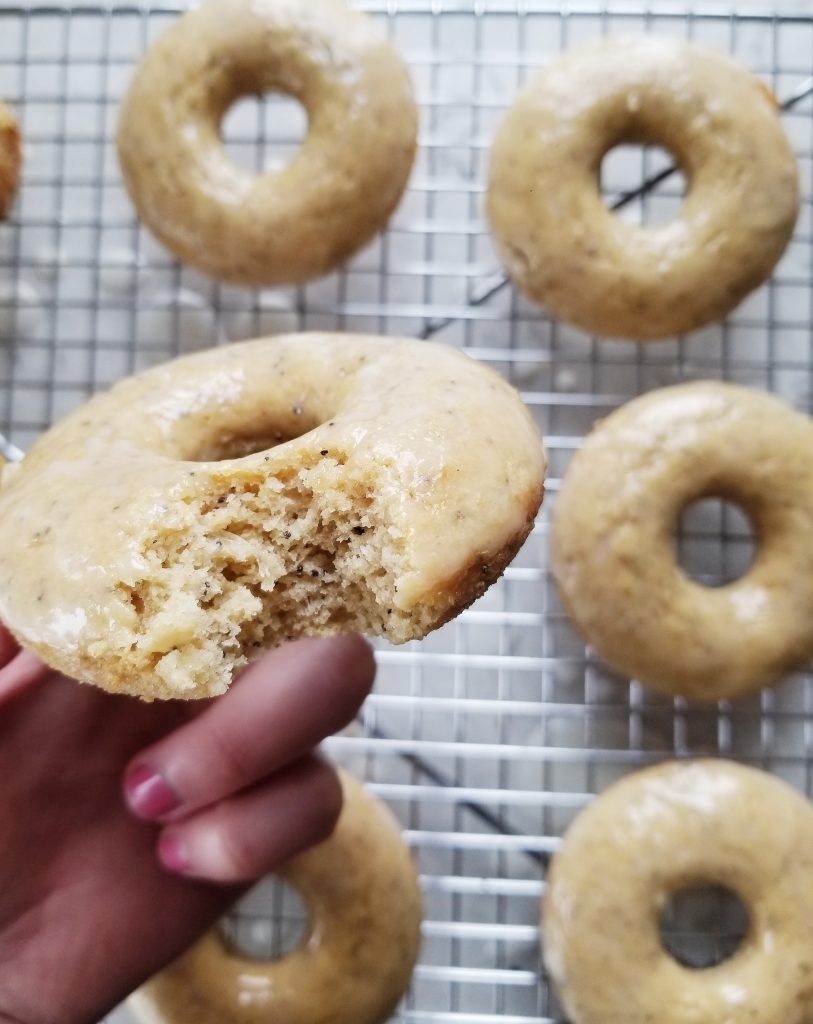 bite shot of a lemon poppy seed doughnut to show the texture 