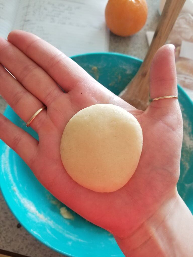 pressed sugar cookie dough in hand