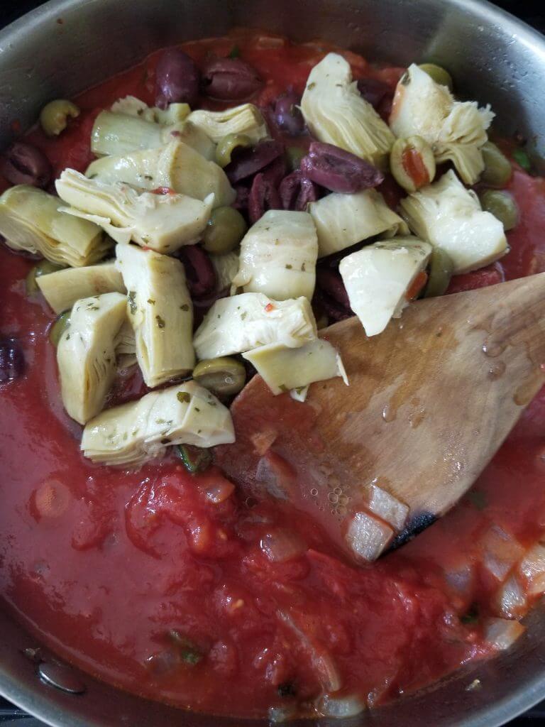 Stewed diced tomatoes with artichoke hearts, Aleppo pepper, and olives