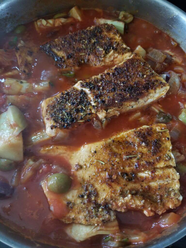 crispy Arabic salmon in a artichoke and tomato sauce to finish cooking