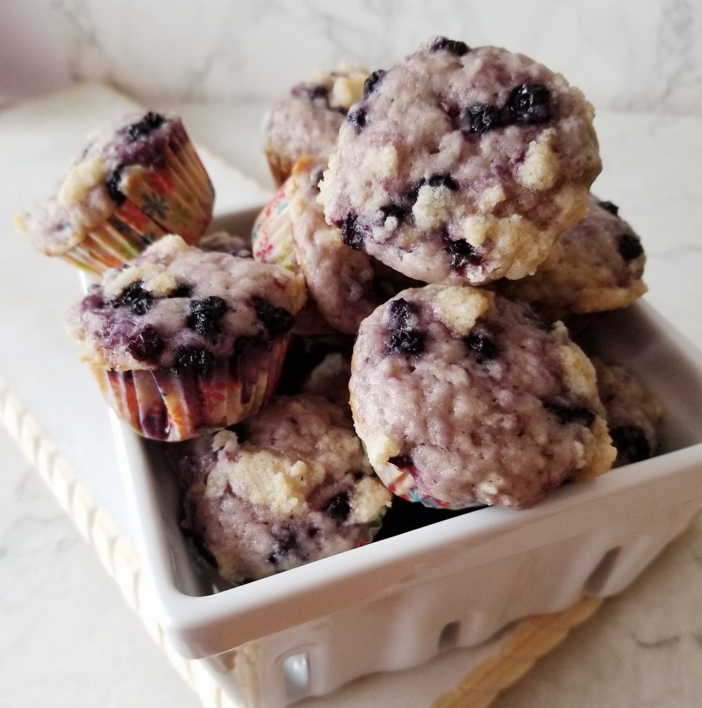blueberry crumble muffins in a blueberry dish 