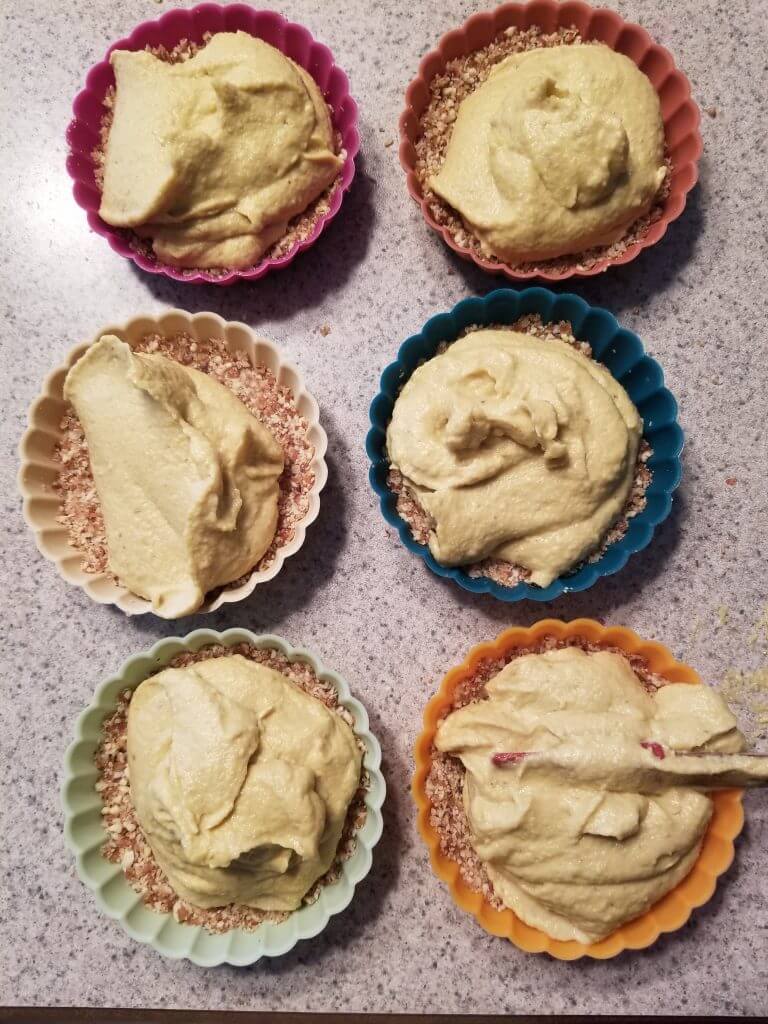 adding the mango cheesecake filling on top of the crust