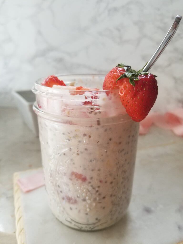 strawberries and cream overnight oats in a mason jar 