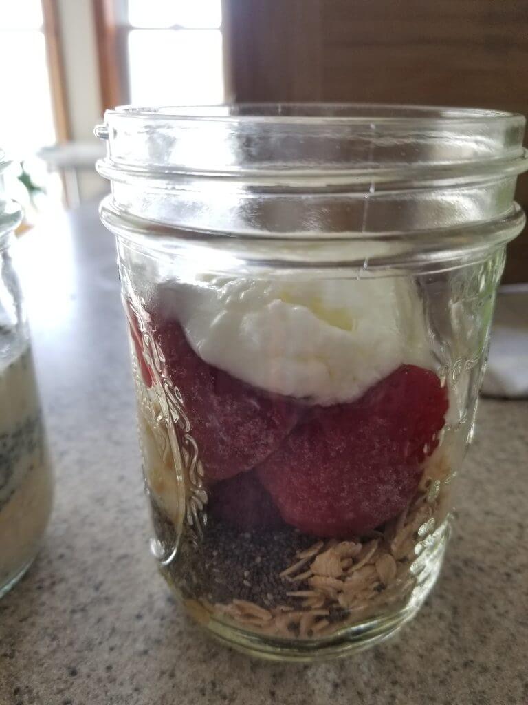 oats, chia seeds, strawberries, and yogurt in a mason jar.