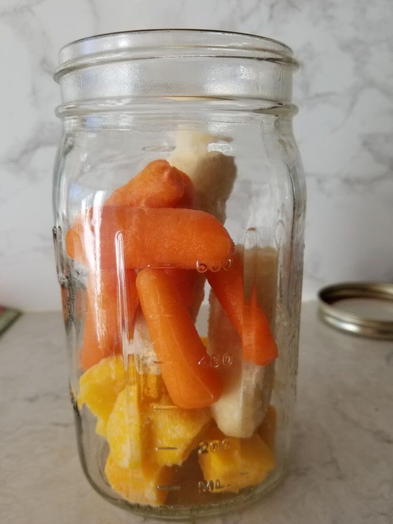 carrots, mango and banana in a mason jar