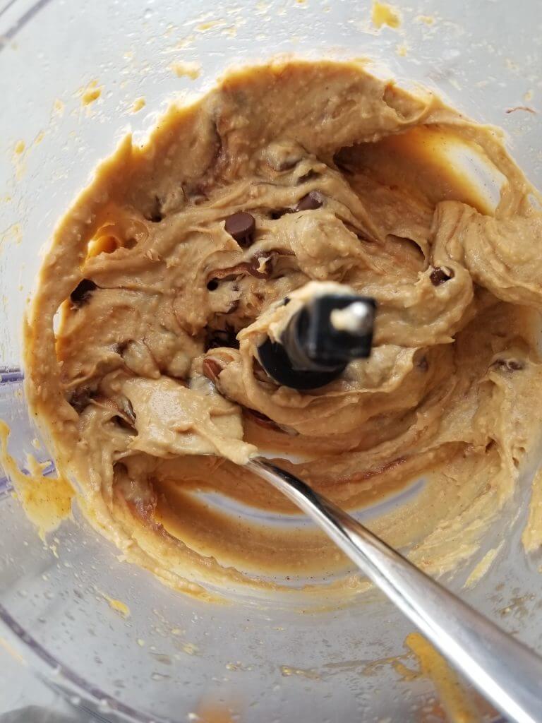 folding in the chocolate chips to the chickpea cookie dough 