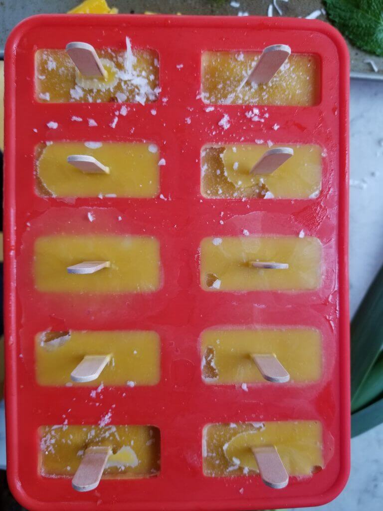 mango popsicles in a popsicle mold