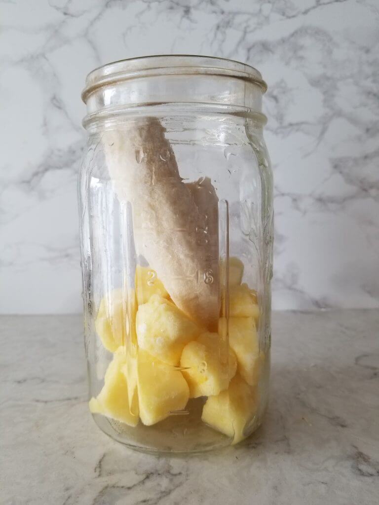 banana and frozen pineapple in a mason jar 