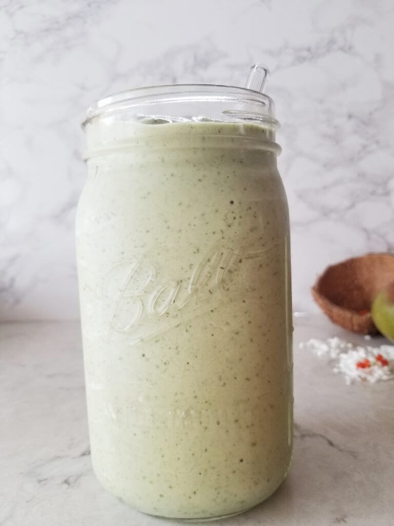 Healthy Tropical Green Smoothie in a mason jar 