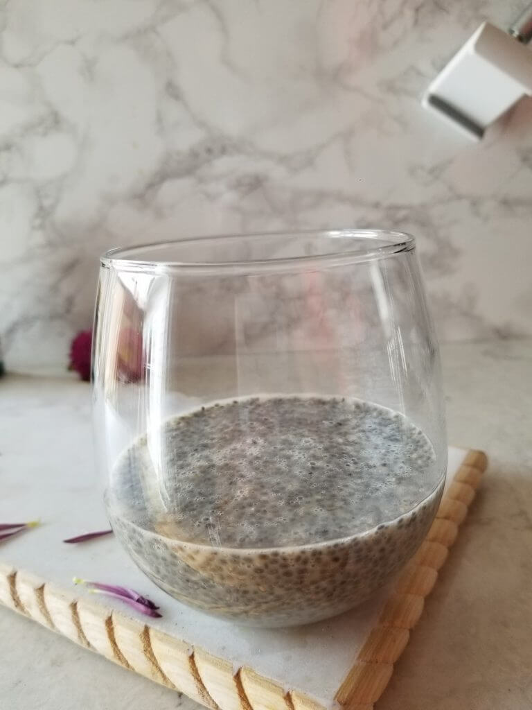 chia pudding in a stemless wine glass for the healthy strawberry smoothie base