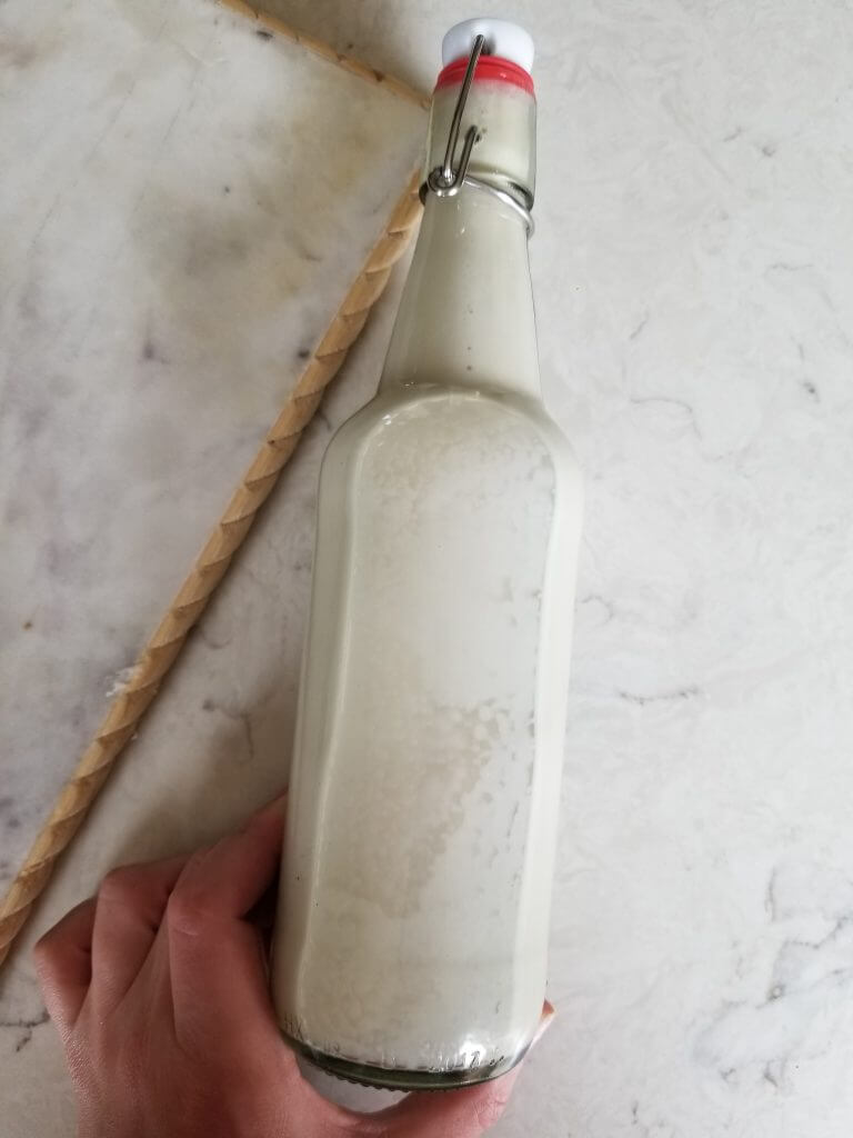 Vanilla almond milk creamer in a swing top milk jar