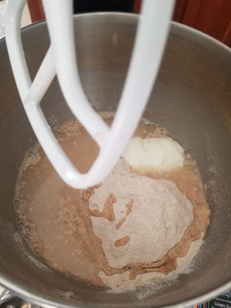 adding the flour and water to the sponge in a standing mixer
