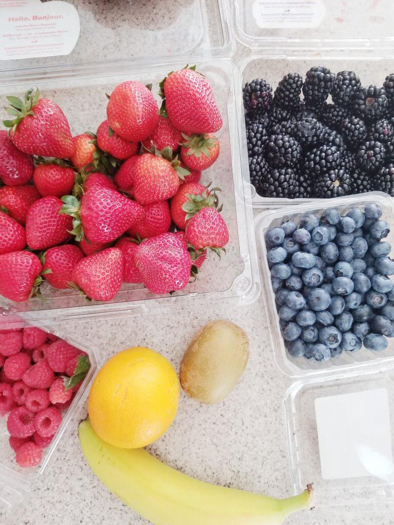 rainbow fruits: strawberries, raspberries, blackberries, blueberries, kiwi, oranges, banana