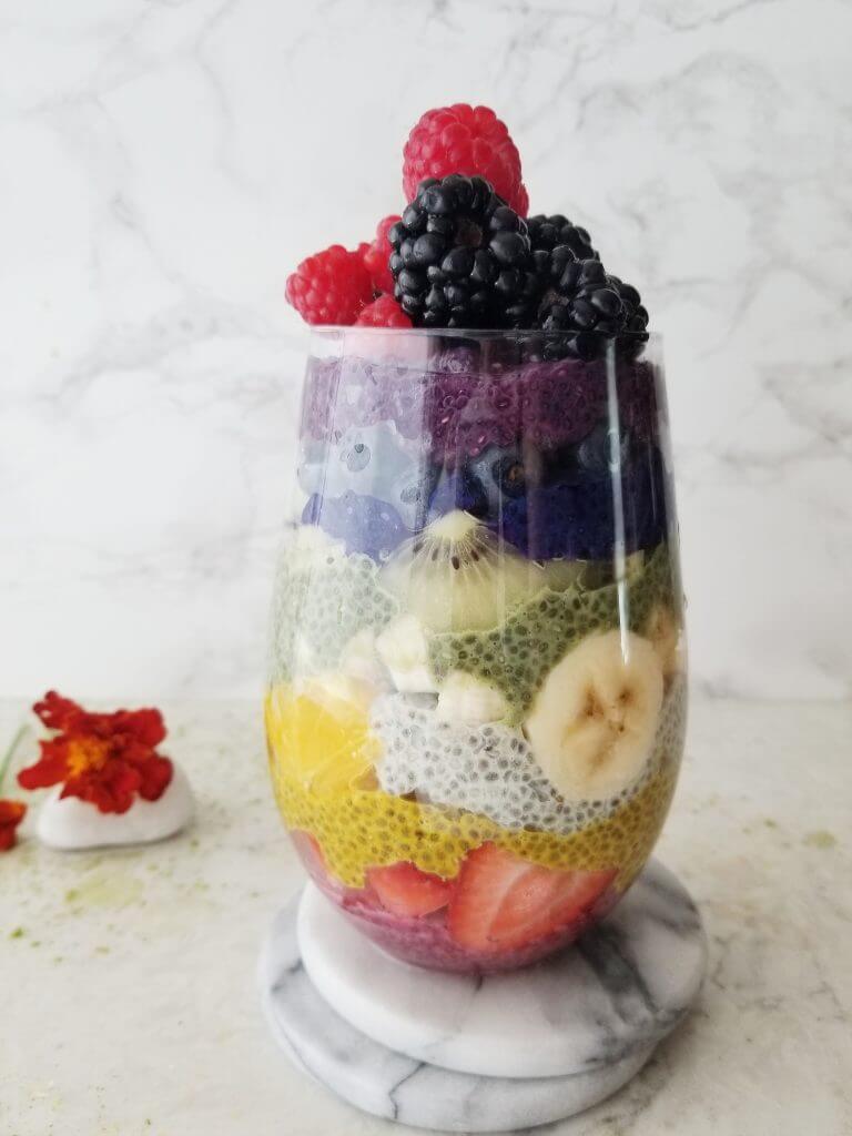 rainbow chia pudding in a jar with colorful fruit